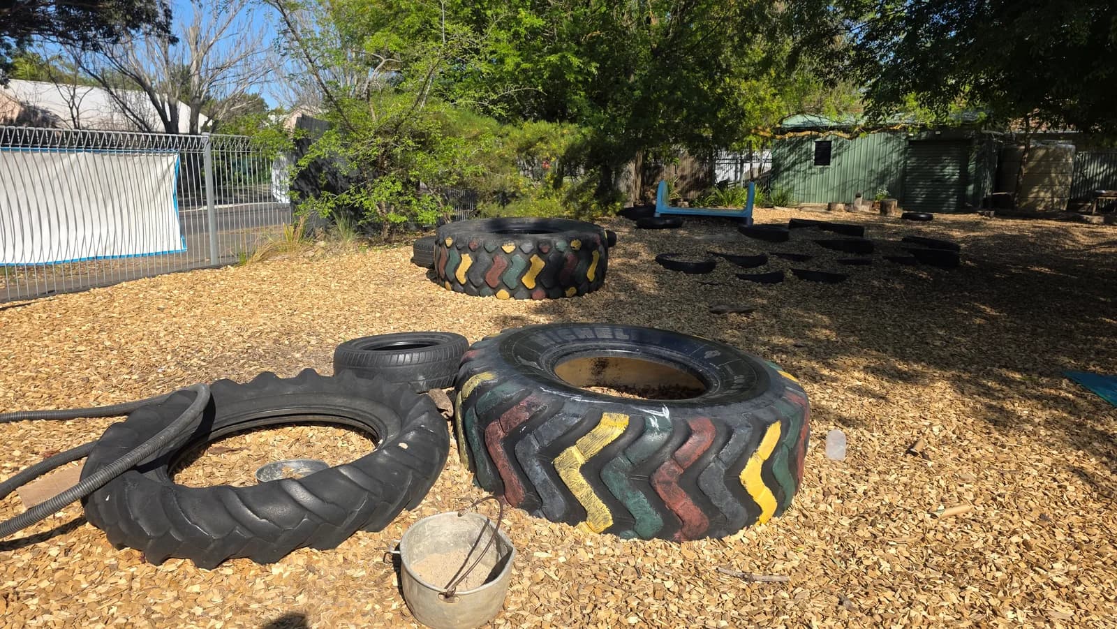 Colourful tyres and gum trees in the centre yard